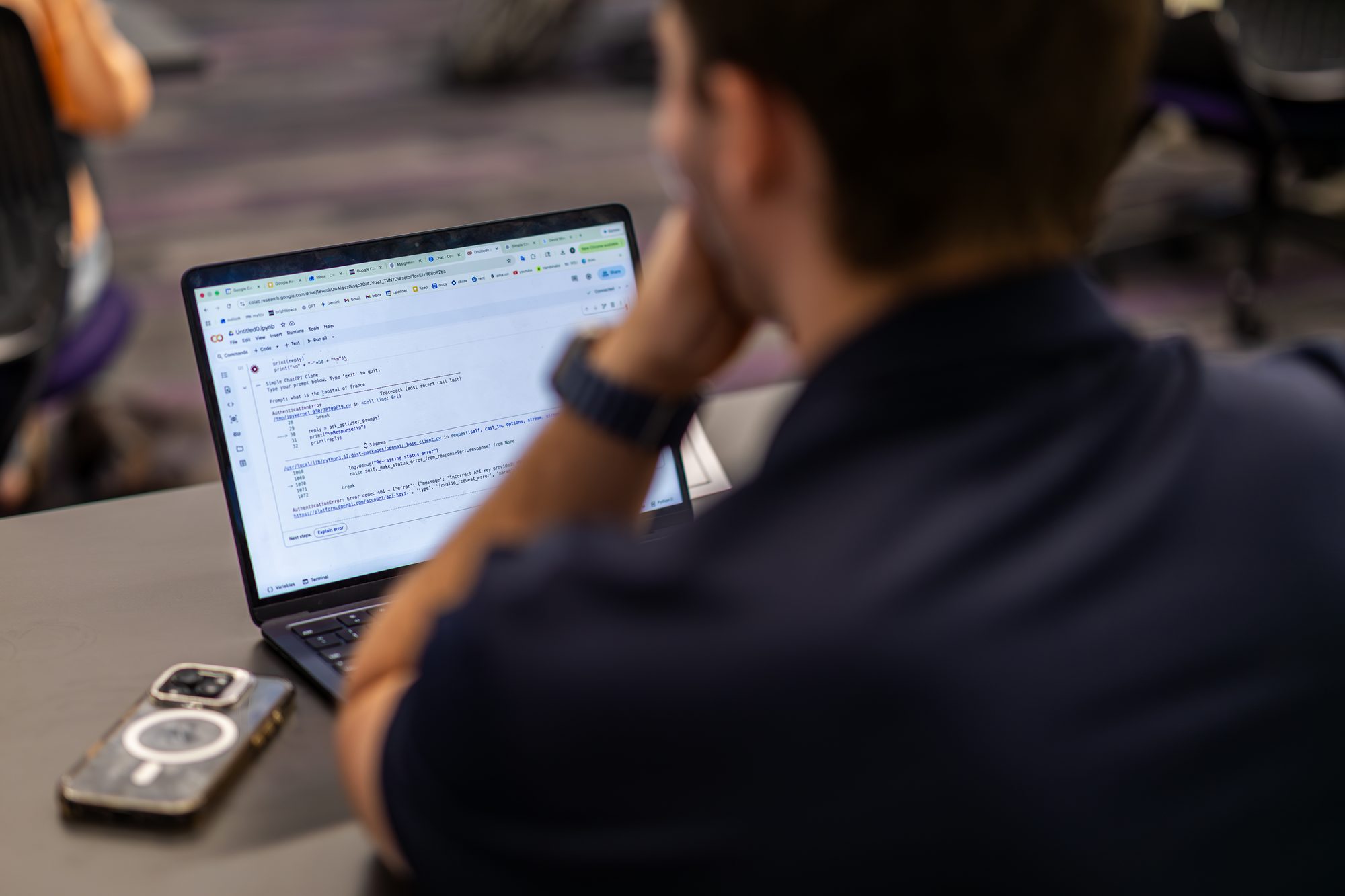 A Neeley student building an AI chatbot on their laptop