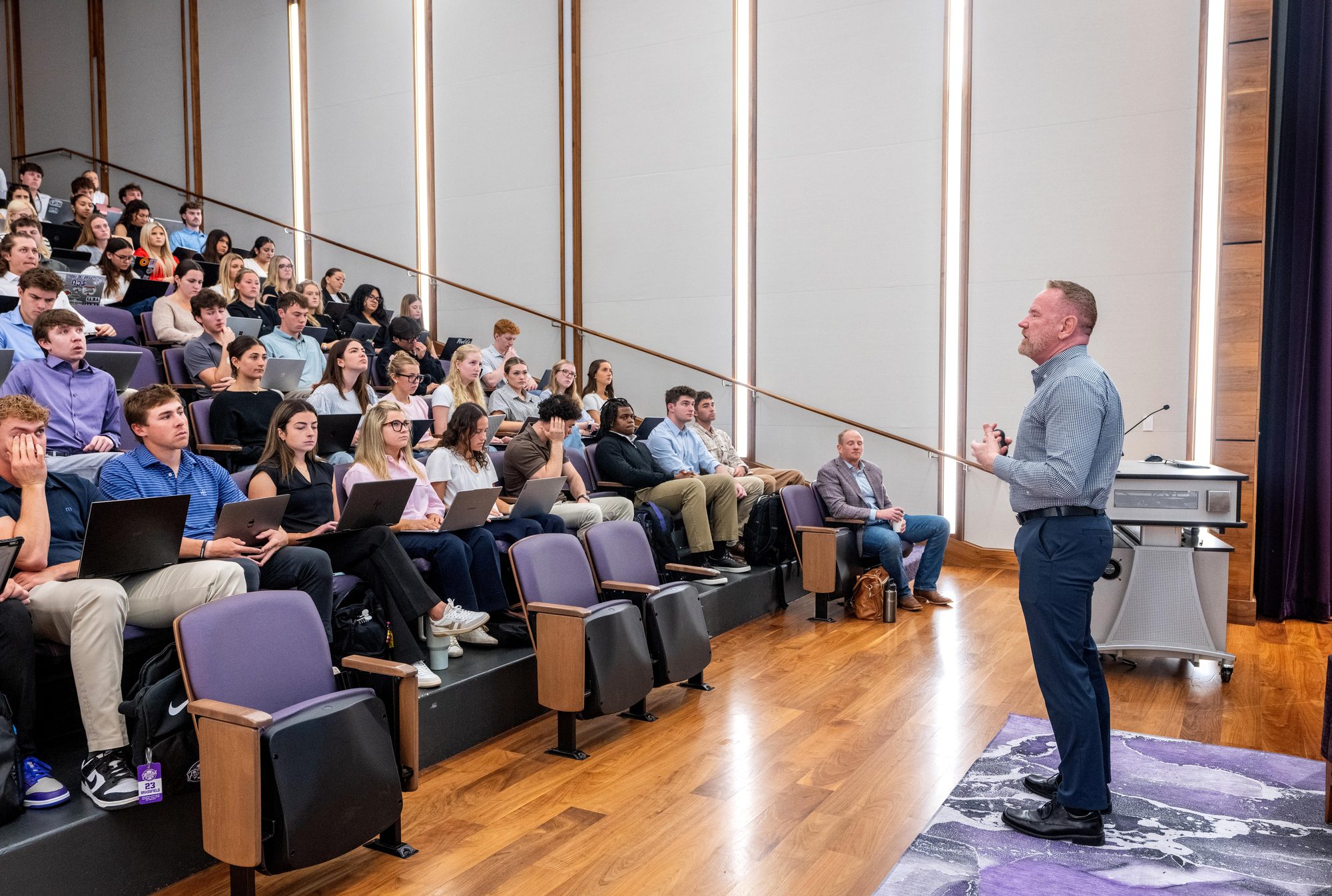A guest speaker addressing a packed Neeley lecture hall