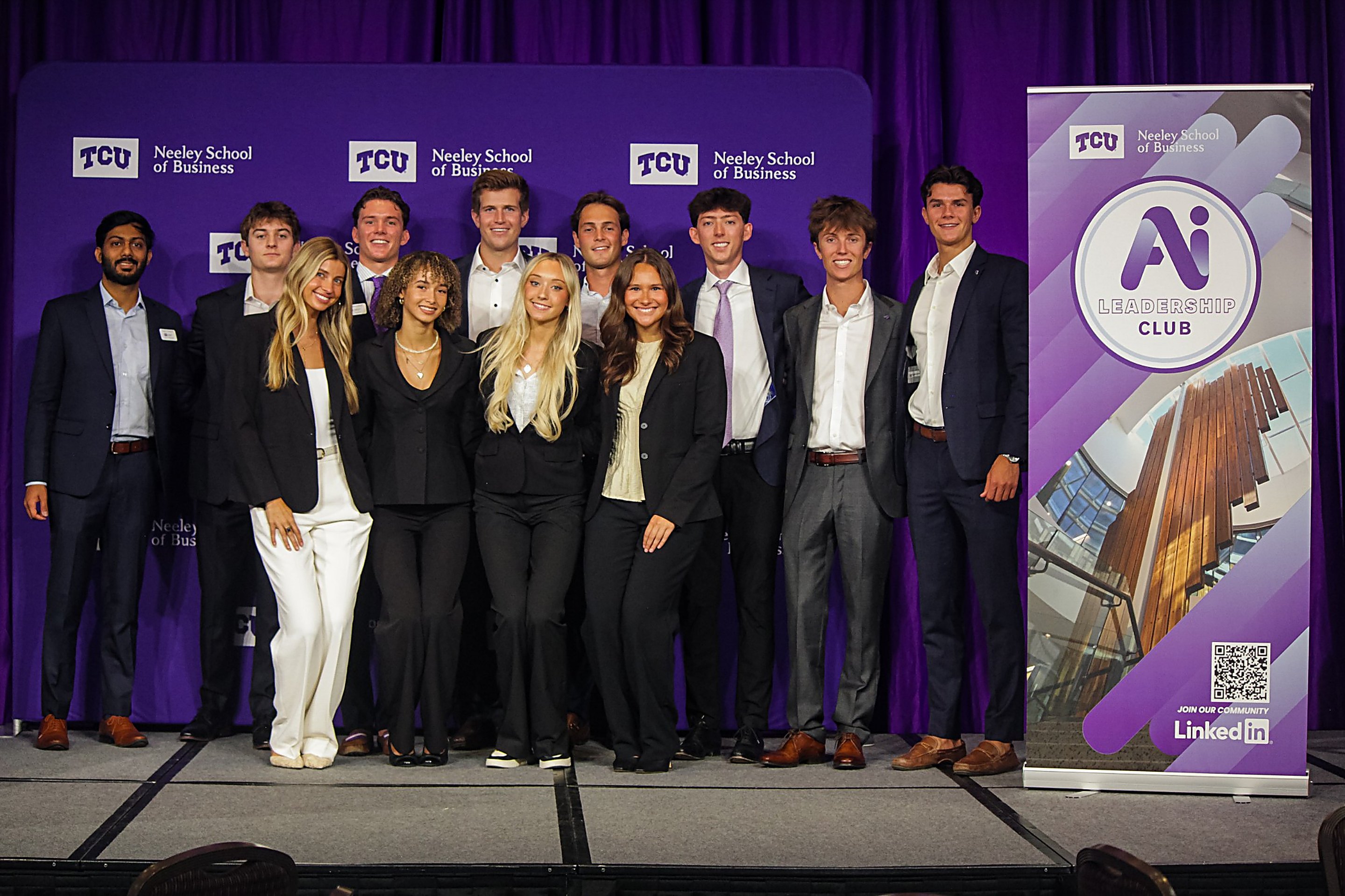 The N.A.I.L. team on stage in front of the TCU Neeley School of Business backdrop and the AI Leadership Club banner